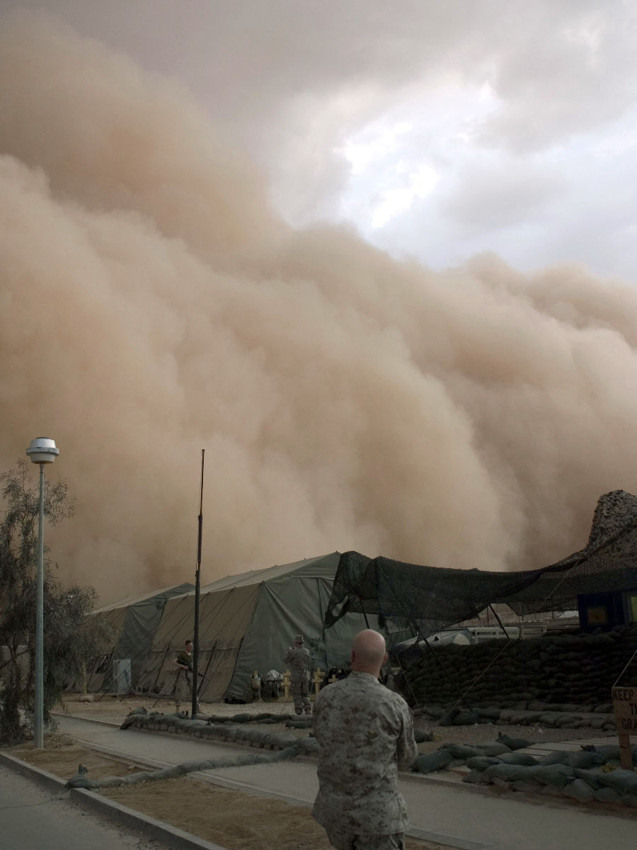 3. No Human Power Can Stop the Dry
                            Desert Winds From Blowing In This Very
                            Powerful, Relentless, Nightfall or Evening
                            Windstorm Which Is Bringing Huge Clouds of
                            Sand (and Dust) - a Massive Sandstorm -
                            Rolling Over and Engulfing the Tents on the
                            Base (Camp), April 27, 2005, Al Asad, Al
                            Anbar Province, Al Jumhuriyah al Iraqiyah -
                            Republic of Iraq. Photo Credit: Corporal
                            Alicia M. Garcia, United States Marine Corps
                            (USMC, http://www.usmc.mil); Navy NewsStand
                            - Eye on the Fleet Photo Gallery
                            (http://www.news.navy.mil/view_photos.asp,
                            050427-M-5607G-006), United States Navy
                            (USN, http://www.navy.mil), United States
                            Department of Defense (DoD,
                            http://www.DefenseLink.mil or
                            http://www.dod.gov), Government of the
                            United States of America (USA).