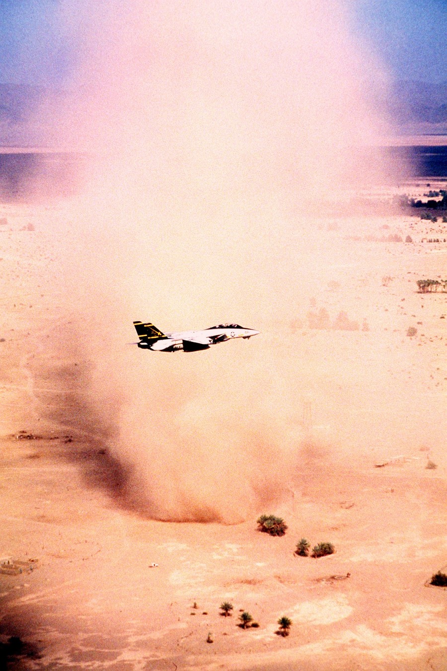 5. A United States Navy F-14A Tomcat
                            Assigned to the 'Swordsmen' of Fighter
                            Squadron Three Two (VF-32) Flies By a Very
                            Big, Very Tall, Column-Shaped Desert
                            Sandstorm, September 1, 1990, In the
                            Vicinity of the Red Sea. Photo Credit: Lt.
                            Cmdr. Dave Parsons, United States Navy (USN,
                            http://www.navy.mil); Defense Visual
                            Information Center (DVIC,
                            http://www.DoDMedia.osd.mil, DNST9102741)
                            and United States Navy (USN,
                            http://www.navy.mil), United States
                            Department of Defense (DoD,
                            http://www.DefenseLink.mil or
                            http://www.dod.gov), Government of the
                            United States of America (USA).