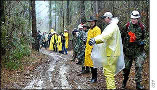 A team lines up to search for shuttle debris