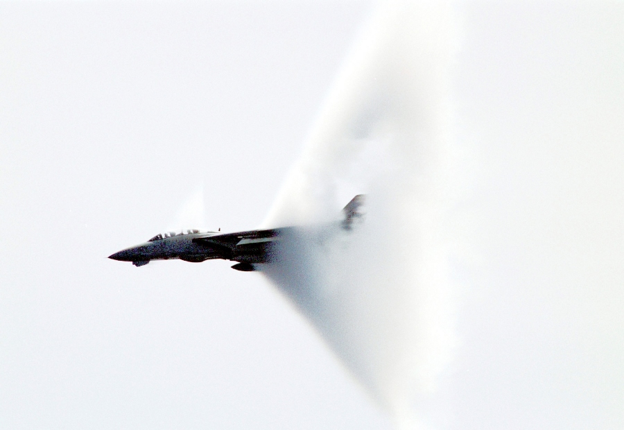 10. An F-14B 'Tomcat' Fighter Jet, April 23, 1999, USS Enterprise (CVN 65), United States Navy Mediterranean Sea. Reaching the sound barrier, breaking the sound barrier: Flying at transonic speeds (flying transonically) -- speeds varying near and at the speed of sound (supersonic) -- can generate impressive condensation clouds caused by the Prandtl-Glauert Singularity. For a scientific explanation, see Professor M. S. Cramer's Gallery of Fluid Mechanics, Prandtl-Glauert Singularity at <http://www.GalleryOfFluidMechanics.com/conden/pg_sing.htm>; and Foundations of Fluid Mechanics, Navier-Stokes Equations Potential Flows: Prandtl-Glauert Similarity Laws at <http://www.Navier-Stokes.net/nspfsim.htm>. Photo Credit: Photographer's Mate Second Class Damon J. Moritz, Image ID: 990423-N-9693M-001, Expeditionary Warfare Division (N75) in the Office of the Chief of Naval Operations, United States Navy (USN, http://www.navy.mil), United States Department of Defense (DoD, http://www.DefenseLink.mil or http://www.dod.gov), Government of the United States of America (USA).