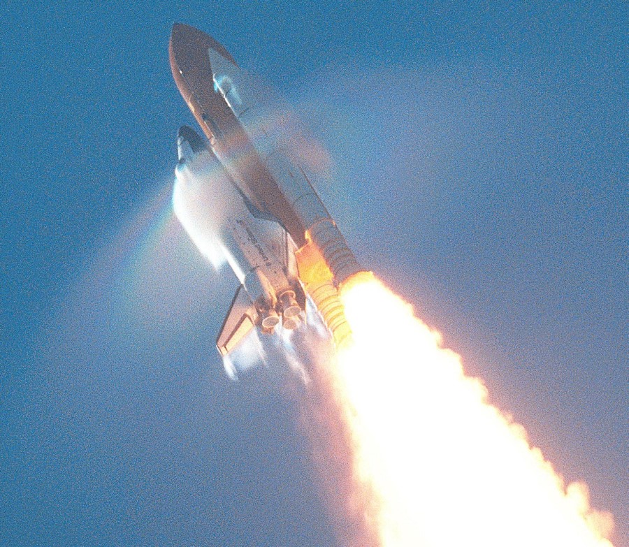 11. STS-106 Mission, Space Shuttle Atlantis, September 8, 2000 at NASA's John F. Kennedy Space Center, State of Florida, USA. Reaching the sound barrier, breaking the sound barrier: Flying at transonic speeds (flying transonically) -- speeds varying near and at the speed of sound (supersonic) -- can generate impressive condensation clouds caused by the Prandtl-Glauert Singularity. For a scientific explanation, see Professor M. S. Cramer's Gallery of Fluid Mechanics, Prandtl-Glauert Singularity at <http://www.GalleryOfFluidMechanics.com/conden/pg_sing.htm>; and Foundations of Fluid Mechanics, Navier-Stokes Equations Potential Flows: Prandtl-Glauert Similarity Laws at <http://www.Navier-Stokes.net/nspfsim.htm>. Photo Credit: Mission: STS-106, Launch of Space Shuttle Atlantis, September 8, 2000, Kennedy Media Gallery (http://mediaarchive.ksc.nasa.gov) Photo Number: KSC-00PP-1416 (http://mediaarchive.ksc.nasa.gov/detail.cfm?mediaid=4720), John F. Kennedy Space Center (KSC, http://www.nasa.gov/centers/kennedy), National Aeronautics and Space Administration (NASA, http://www.nasa.gov), Government of the United States of America. The effect as described by NASA in the photo caption <http://mediaarchive.ksc.nasa.gov/detail.cfm?mediaid=4720>: This view of the shock wave condensation collars backlit by the sun occurred during the launch of Atlantis on STS-106 and was captured on an engineering 35mm motion picture film. One frame was digitized to make this still image. Although the primary effect is created by the Orbiter forward fuselage, secondary effects can be seen on the SRB forward skirt, Orbiter vertical stabilizer and wing trailing edges (behind SSME's).