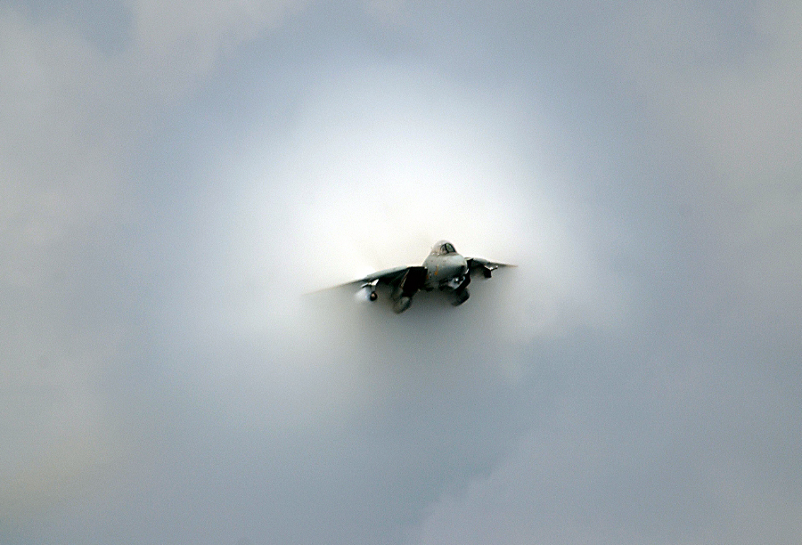 15. An F-14D Tomcat Fighter Jet, July 28, 2006, USS Theodore Roosevelt (CVN 71), United States Navy, Atlantic Ocean. Reaching the sound barrier, breaking the sound barrier: Flying at transonic speeds (flying transonically) -- speeds varying near and at the speed of sound (supersonic) -- can generate impressive condensation clouds caused by the Prandtl-Glauert Singularity. For a scientific explanation, see Professor M. S. Cramer's Gallery of Fluid Mechanics, Prandtl-Glauert Singularity at <http://www.GalleryOfFluidMechanics.com/conden/pg_sing.htm>; and Foundations of Fluid Mechanics, Navier-Stokes Equations Potential Flows: Prandtl-Glauert Similarity Laws at <http://www.Navier-Stokes.net/nspfsim.htm>. Photo Credit: Mass Communication Specialist 3rd Class Nathan Laird, Navy NewsStand - Eye on the Fleet Photo Gallery (http://www.news.navy.mil/view_photos.asp, 060728-N-7241L-026), United States Navy (USN, http://www.navy.mil), United States Department of Defense (DoD, http://www.DefenseLink.mil or http://www.dod.gov), Government of the United States of America (USA). See also the companion photo in 'F-14 near supersonic fly-by' at <http://www.navy.mil/view_single.asp?id=37558>.