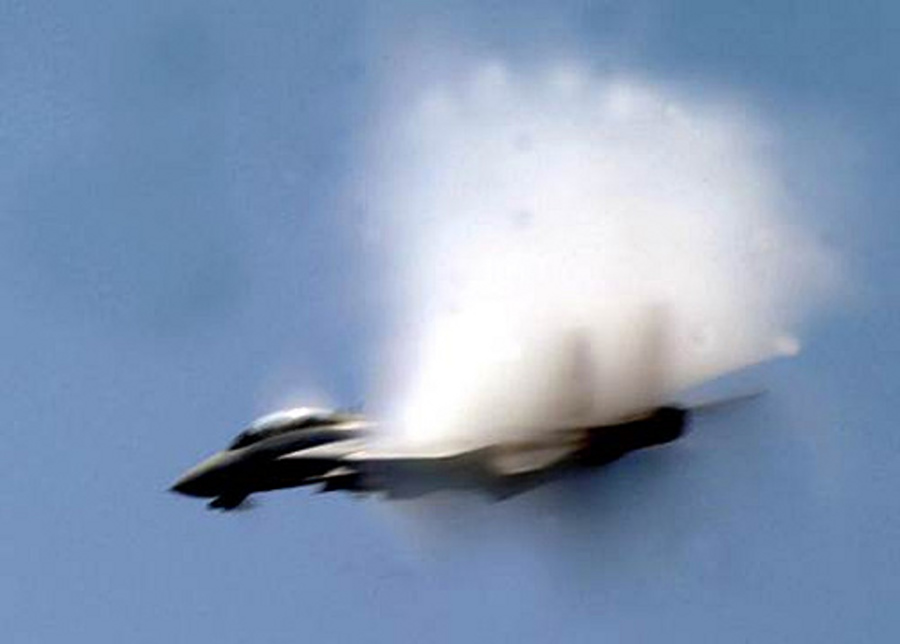 6. A Fighter Jet From the Carrier Air Wing 8, 'Black Lions' VFA-213, United States Navy, Mediterranean Sea. Reaching the sound barrier, breaking the sound barrier: Flying at transonic speeds (flying transonically) -- speeds varying near and at the speed of sound (supersonic) -- can generate impressive condensation clouds caused by the Prandtl-Glauert Singularity. For a scientific explanation, see Professor M. S. Cramer's Gallery of Fluid Mechanics, Prandtl-Glauert Singularity at <http://www.GalleryOfFluidMechanics.com/conden/pg_sing.htm>; and Foundations of Fluid Mechanics, Navier-Stokes Equations Potential Flows: Prandtl-Glauert Similarity Laws at <http://www.Navier-Stokes.net/nspfsim.htm>. Photo Credit: Photographer's Mate Airman Michael McCannCole, Defend America News Photo (http://www.DefendAmerica.mil, May 2003, Breaking the Barrier, npi051203a1), United States Department of Defense (DoD, http://www.DefenseLink.mil or http://www.dod.gov), Government of the United States of America (USA).