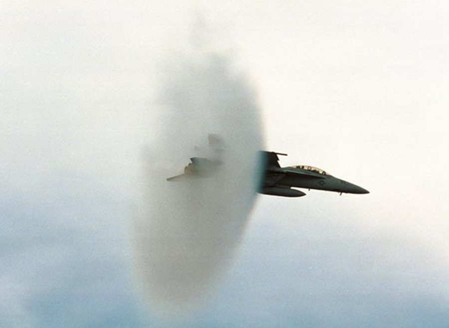 8. An F/A-18E Super Hornet Fighter Jet, United States Navy, Off the Coast of Southern California, United States. Reaching the sound barrier, breaking the sound barrier: Flying at transonic speeds (flying transonically) -- speeds varying near and at the speed of sound (supersonic) -- can generate impressive condensation clouds caused by the Prandtl-Glauert Singularity. For a scientific explanation, see Professor M. S. Cramer's Gallery of Fluid Mechanics, Prandtl-Glauert Singularity at <http://www.GalleryOfFluidMechanics.com/conden/pg_sing.htm>; and Foundations of Fluid Mechanics, Navier-Stokes Equations Potential Flows: Prandtl-Glauert Similarity Laws at <http://www.Navier-Stokes.net/nspfsim.htm>. Photo Credit: PHAA Jeremie Kerns, USS Carl Vinson (CVN 70) Photo Gallery (http://www.vinson.navy.mil/photos/oct00.html, October 2000, VFA-122 experts breaking the sound barrier in the F/A 18E), USS Carl Vinson (CVN 70) (http://www.vinson.navy.mil), United States Navy (USN, http://www.navy.mil), United States Department of Defense (DoD, http://www.DefenseLink.mil or http://www.dod.gov), Government of the United States of America (USA).