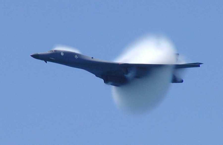 13. An F/A-18C Hornet Fighter Jet Assigned to the 'Golden Dragons' of Strike Fighter Squadron One Nine Two (VFA-192). August 17, 2005, Pacific Ocean. Reaching the sound barrier, breaking the sound barrier: Flying at transonic speeds (flying transonically) -- speeds varying near and at the speed of sound (supersonic) -- can generate impressive condensation clouds caused by the Prandtl-Glauert Singularity. For a scientific explanation, see Professor M. S. Cramer's Gallery of Fluid Mechanics, Prandtl-Glauert Singularity at <http://www.GalleryOfFluidMechanics.com/conden/pg_sing.htm>; and Foundations of Fluid Mechanics, Navier-Stokes Equations Potential Flows: Prandtl-Glauert Similarity Laws at <http://www.Navier-Stokes.net/nspfsim.htm>. Photo Credit: Photographer's Mate 3rd Class Jonathan Chandler, Navy NewsStand - Eye on the Fleet Photo Gallery (http://www.news.navy.mil/view_photos.asp, 050817-N-3488C-151), United States Navy (USN, http://www.navy.mil), United States Department of Defense (DoD, http://www.DefenseLink.mil or http://www.dod.gov), Government of the United States of America (USA). See the companion photo in 'An F/A-18C Hornet conducts a high-speed pass prior to breaking the speed of sound.' at <http://www.news.navy.mil/view_single.asp?id=27228>.