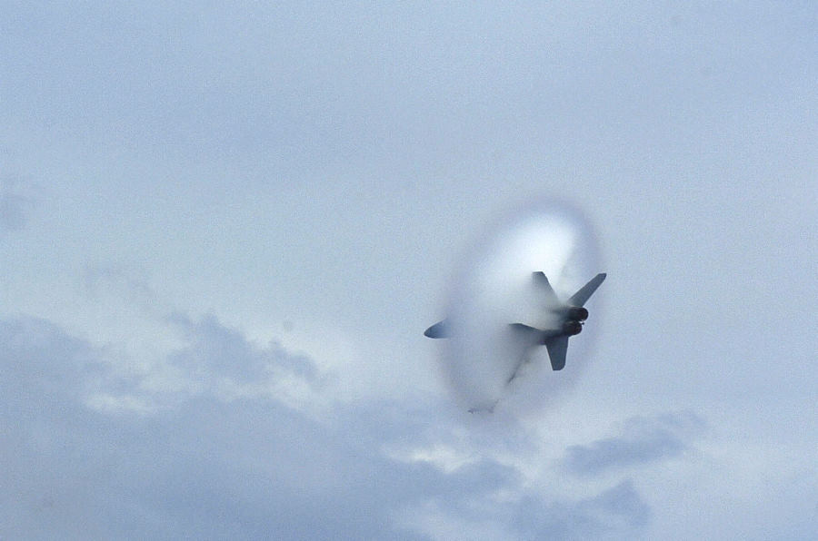 5. An F/A-18F Super Hornet Fighter Jet Assigned to Strike Fighter Squadron One Zero Two (VFA-102), Carrier Air Wing Five (CVW-5), USS Kitty Hawk (CV 63), United States Navy, September 11, 2006, East China Sea. Flying at transonic speeds (flying transonically) -- speeds varying near and at the speed of sound (supersonic) -- can generate impressive condensation clouds caused by the Prandtl-Glauert Singularity. For a scientific explanation, see Professor M. S. Cramer's Gallery of Fluid Mechanics, Prandtl-Glauert Singularity at <http://www.GalleryOfFluidMechanics.com/conden/pg_sing.htm>; and Foundations of Fluid Mechanics, Navier-Stokes Equations Potential Flows: Prandtl-Glauert Similarity Laws at <http://www.Navier-Stokes.net/nspfsim.htm>. Photo Credit: Mass Communication Specialist Seaman Joshua Wayne LeGrand, Navy NewsStand - Eye on the Fleet Photo Gallery (http://www.news.navy.mil/view_photos.asp, 060911-N-8604L-741), United States Navy (USN, http://www.navy.mil), United States Department of Defense (DoD, http://www.DefenseLink.mil or http://www.dod.gov), Government of the United States of America (USA).