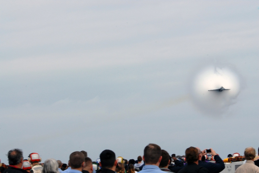 12. A Transonic F/A-18E Super Hornet Jet Fighter Performs a High-Speed Flyby Above the United States Navy Nimitz-Class Aircraft Carrier USS Ronald Reagan (CVN 76), Friends and Family Day Cruise, November 11, 2007, State of California, USA. Flying at transonic speeds (flying transonically) -- speeds varying near and at the speed of sound (supersonic) -- can generate impressive condensation clouds caused by the Prandtl-Glauert Singularity. For a scientific explanation, see Professor M. S. Cramer's Gallery of Fluid Mechanics, Prandtl-Glauert Singularity at <http://www.GalleryOfFluidMechanics.com/conden/pg_sing.htm>; and Foundations of Fluid Mechanics, Navier-Stokes Equations Potential Flows: Prandtl-Glauert Similarity Laws at <http://www.Navier-Stokes.net/nspfsim.htm>. Photo Credit: Mass Communication Specialist 2nd Class Joseph M. Buliavac, Navy NewsStand - Eye on the Fleet Photo Gallery (http://www.news.navy.mil/view_photos.asp, 071111-N-3659B-102), United States Navy (USN, http://www.navy.mil), United States Department of Defense (DoD, http://www.DefenseLink.mil or http://www.dod.gov), Government of the United States of America (USA).